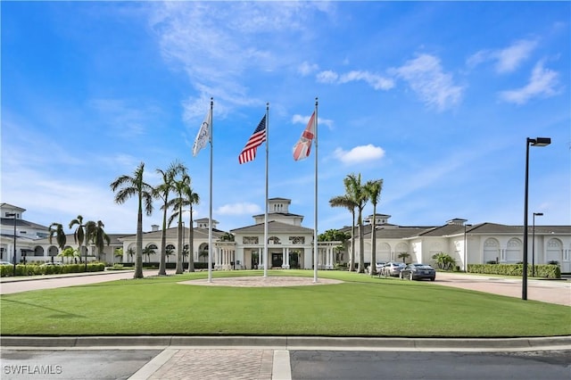 view of property's community with a lawn