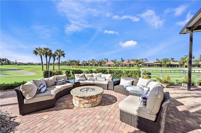 view of patio with an outdoor living space with a fire pit