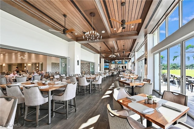 dining space featuring ceiling fan with notable chandelier, beam ceiling, wooden ceiling, and dark wood-type flooring