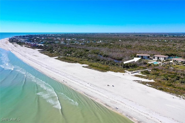 drone / aerial view with a beach view and a water view