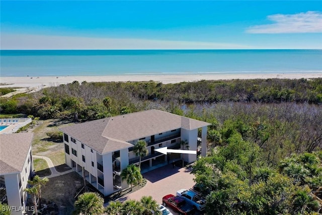 birds eye view of property featuring a water view and a view of the beach