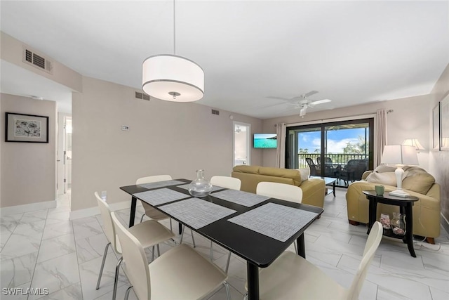 dining space featuring ceiling fan