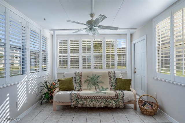 sunroom featuring ceiling fan and plenty of natural light