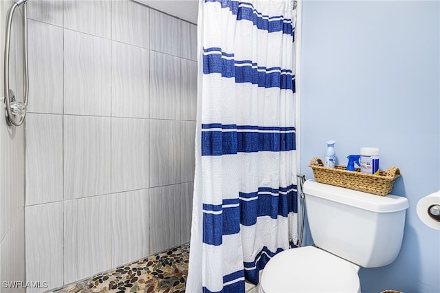 bathroom with toilet and curtained shower