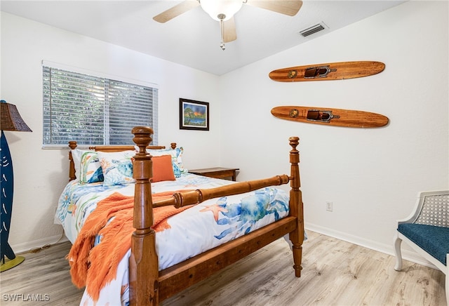 bedroom featuring ceiling fan, light hardwood / wood-style floors, and lofted ceiling