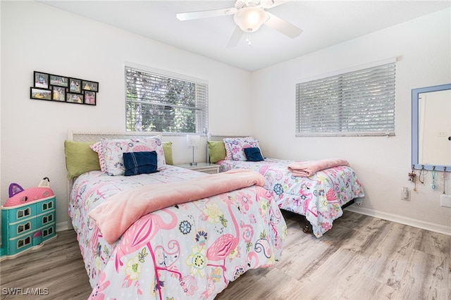 bedroom with hardwood / wood-style floors and ceiling fan