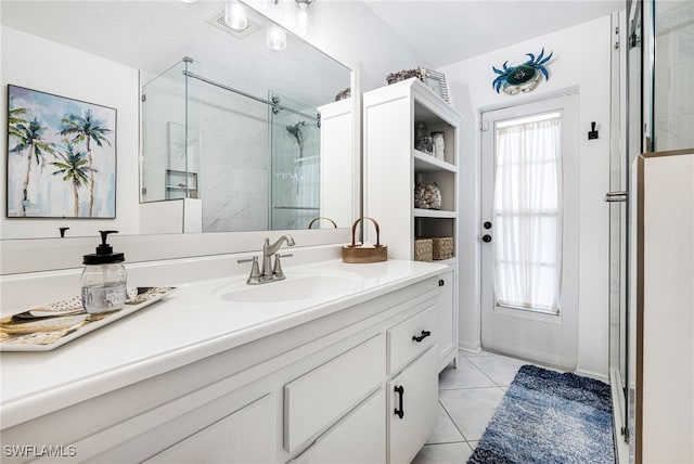 bathroom featuring tile patterned flooring, plenty of natural light, walk in shower, and vanity