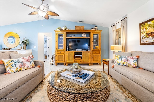 tiled living room featuring ceiling fan and lofted ceiling