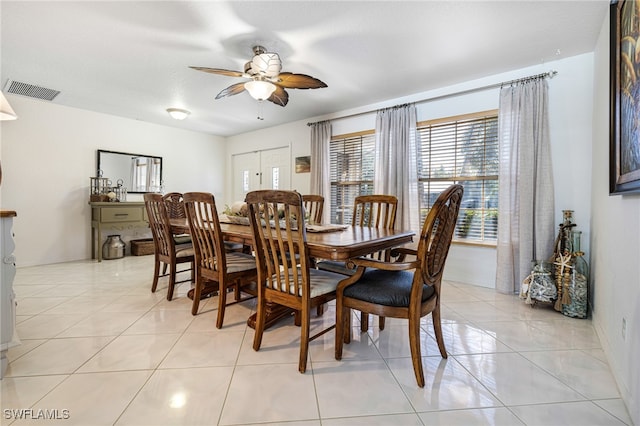 tiled dining room featuring ceiling fan