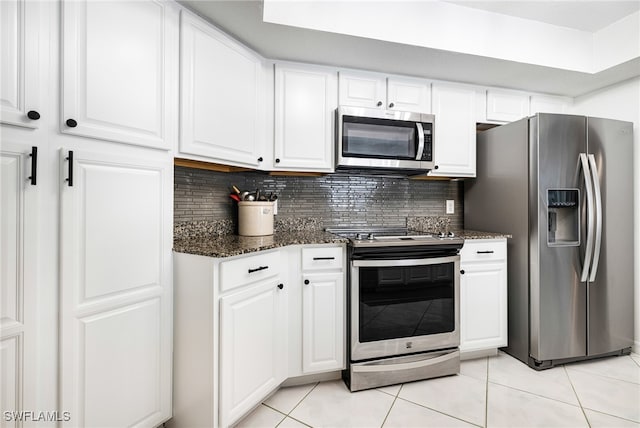 kitchen with white cabinets, decorative backsplash, light tile patterned flooring, and appliances with stainless steel finishes