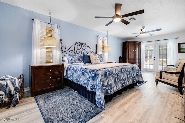 bedroom featuring ceiling fan, french doors, a textured ceiling, access to outside, and light wood-type flooring