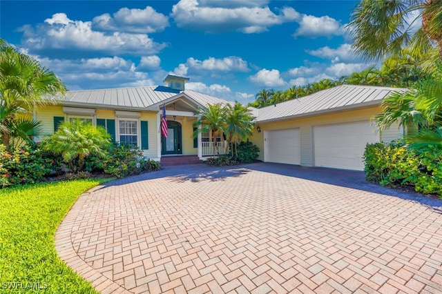 single story home with covered porch and a garage