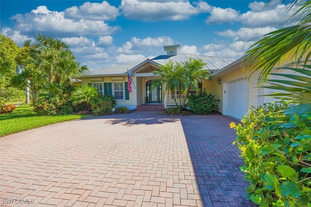 view of front of property with a porch and a garage