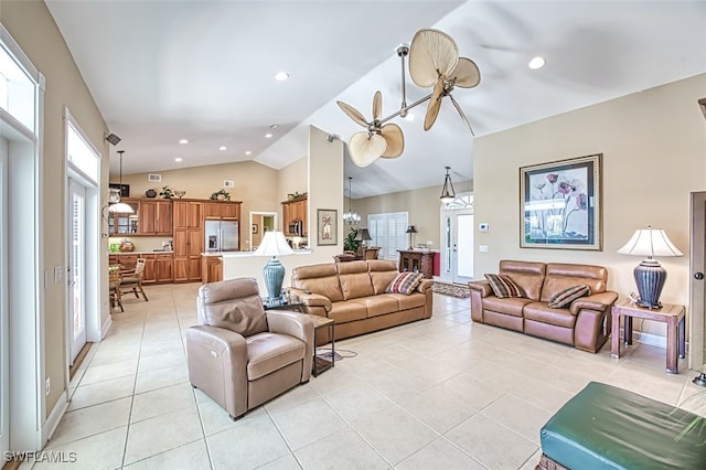 tiled living room featuring lofted ceiling and a notable chandelier