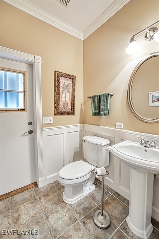 bathroom featuring toilet and ornamental molding