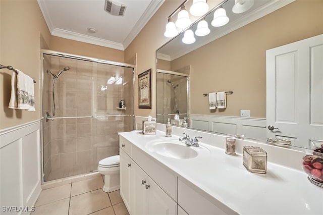 bathroom featuring tile patterned floors, vanity, ornamental molding, and a shower with door