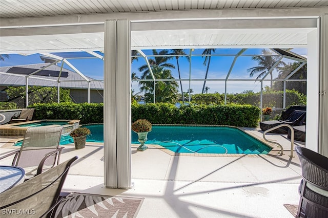 view of swimming pool featuring a patio area and an in ground hot tub