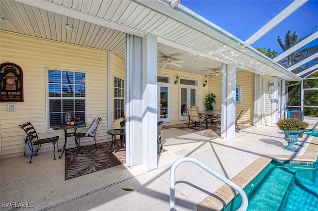 view of patio / terrace with ceiling fan and glass enclosure