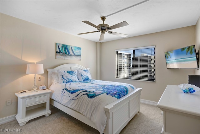 bedroom with ceiling fan and light colored carpet