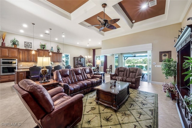 living room with light tile patterned floors, ornamental molding, ceiling fan, and coffered ceiling