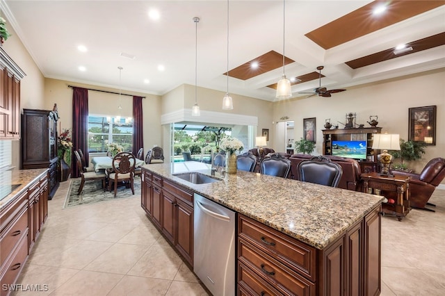 kitchen featuring pendant lighting, dishwasher, crown molding, ceiling fan, and an island with sink