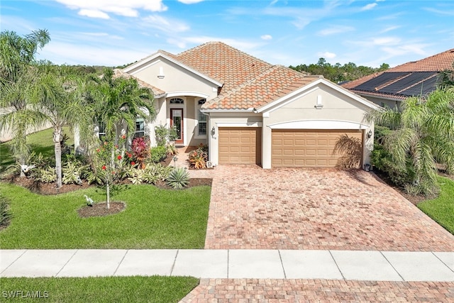 mediterranean / spanish home with a front yard and a garage