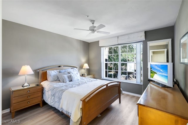 bedroom with wood-type flooring and ceiling fan