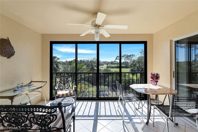 sunroom featuring ceiling fan