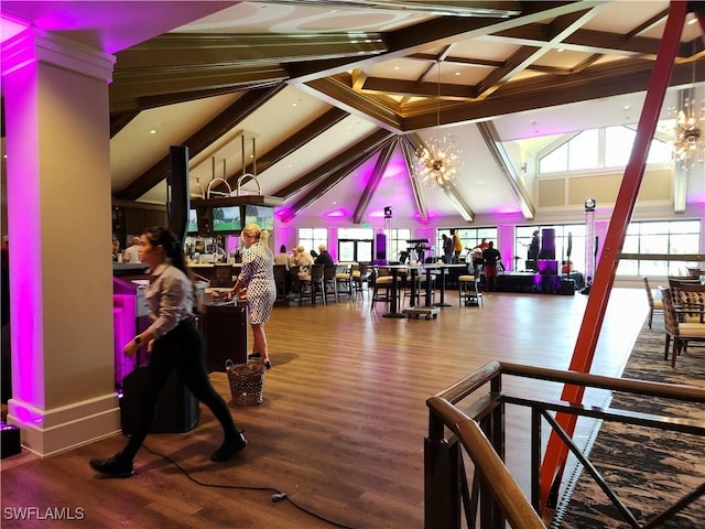 interior space featuring hardwood / wood-style floors, high vaulted ceiling, and a chandelier