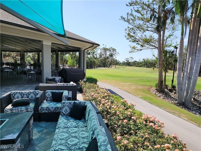 view of home's community featuring a lawn, a patio area, and an outdoor hangout area