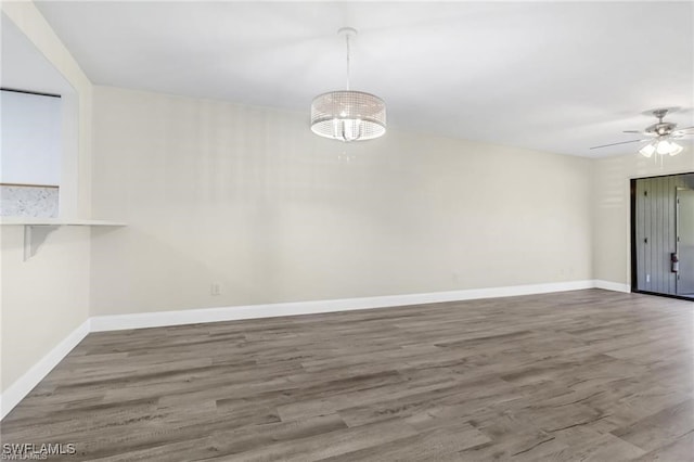 unfurnished dining area with dark hardwood / wood-style floors and ceiling fan