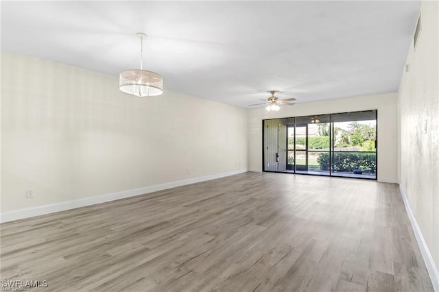 spare room with ceiling fan and light wood-type flooring