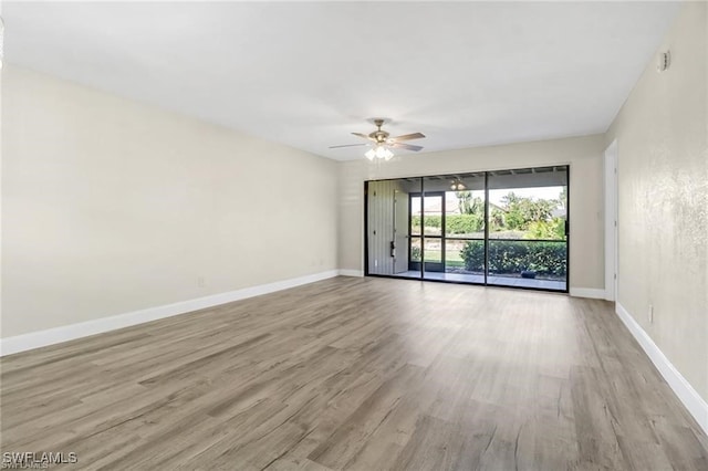 empty room featuring ceiling fan and light hardwood / wood-style flooring