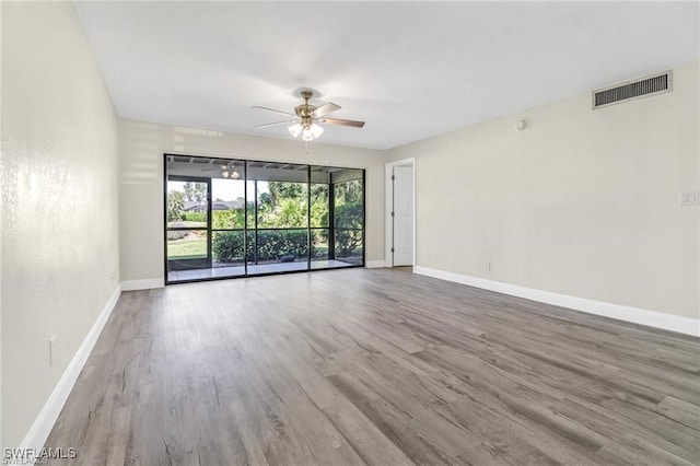 unfurnished room featuring ceiling fan and hardwood / wood-style floors