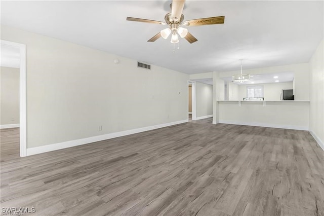 unfurnished living room featuring hardwood / wood-style floors and ceiling fan