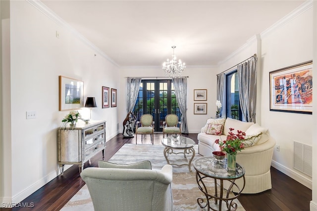 living room with a chandelier, ornamental molding, french doors, and dark wood-type flooring