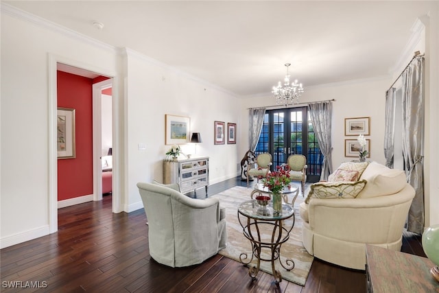 living room featuring dark hardwood / wood-style floors, ornamental molding, french doors, and a chandelier