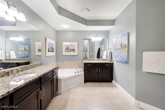 bathroom featuring tile patterned floors, a bathtub, and vanity