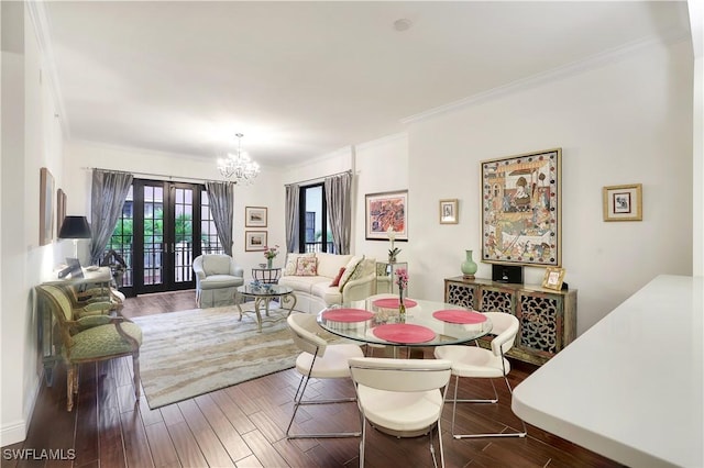 dining room featuring french doors, ornamental molding, hardwood / wood-style floors, and a notable chandelier