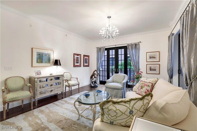 living room with crown molding, dark wood-type flooring, a notable chandelier, and french doors