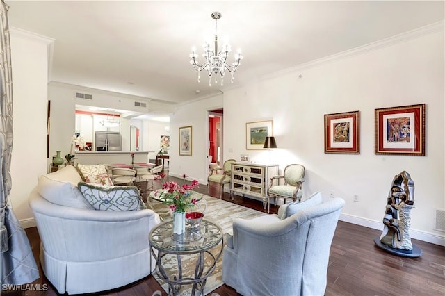 living room with ornamental molding, an inviting chandelier, and dark hardwood / wood-style flooring