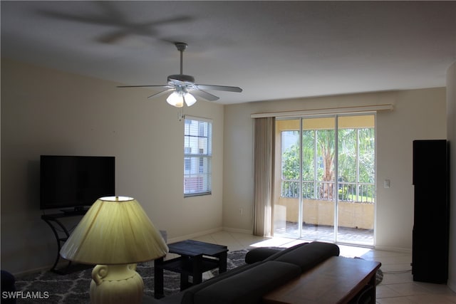 living room featuring ceiling fan and light tile patterned floors