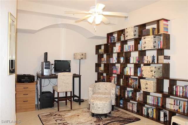 tiled office space featuring ceiling fan