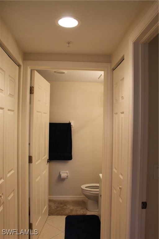 bathroom featuring tile patterned flooring and toilet