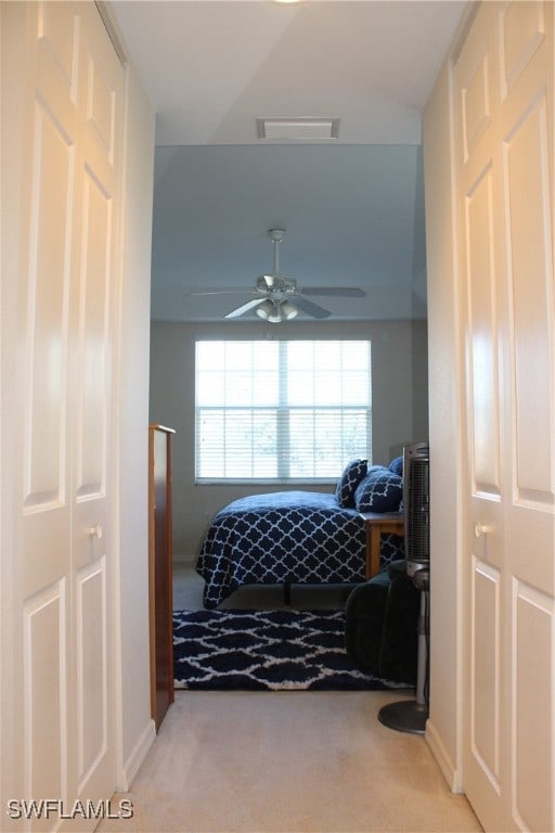 bedroom with light carpet and ceiling fan