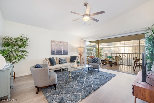 living room with light hardwood / wood-style flooring, vaulted ceiling, and ceiling fan