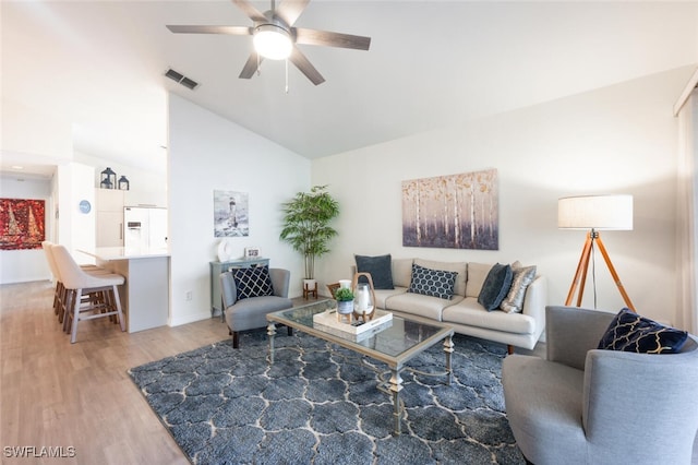 living room featuring hardwood / wood-style flooring, ceiling fan, and lofted ceiling