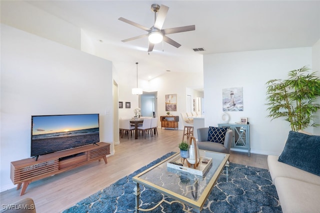 living room featuring ceiling fan and wood-type flooring