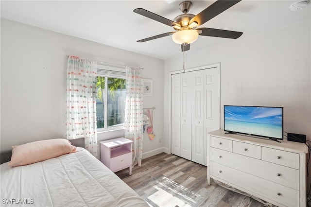 bedroom with ceiling fan, a closet, and light wood-type flooring