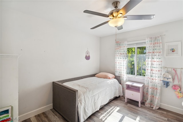 bedroom with hardwood / wood-style floors and ceiling fan